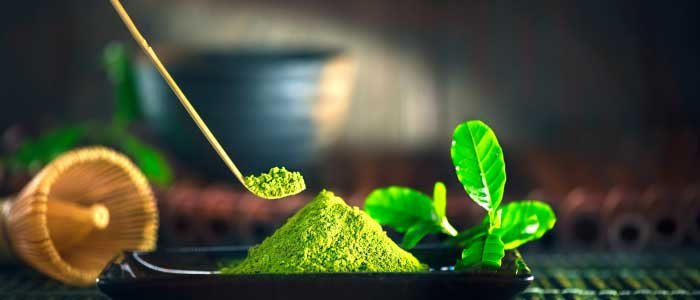 taking a scoop of matcha green tea